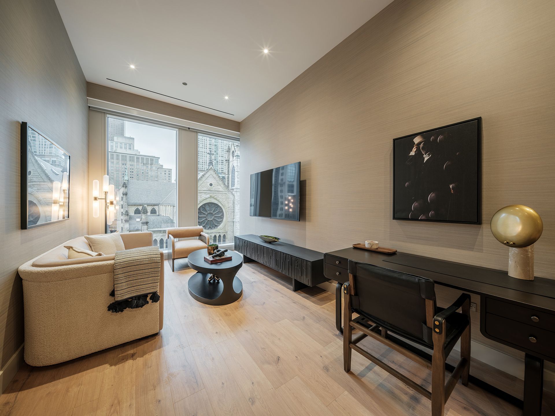 A living room with a couch , chair , table and television.