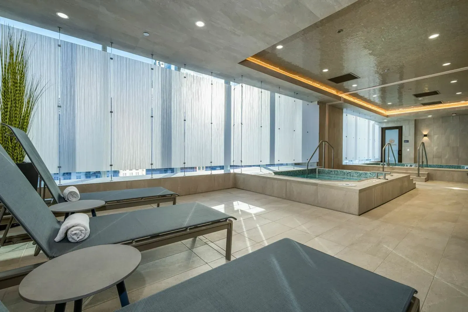 An indoor pool with lounge chairs and towels