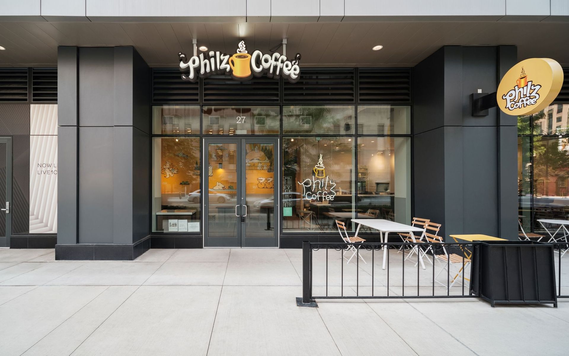 The exterior of a Philz Coffee shop with outdoor seating.