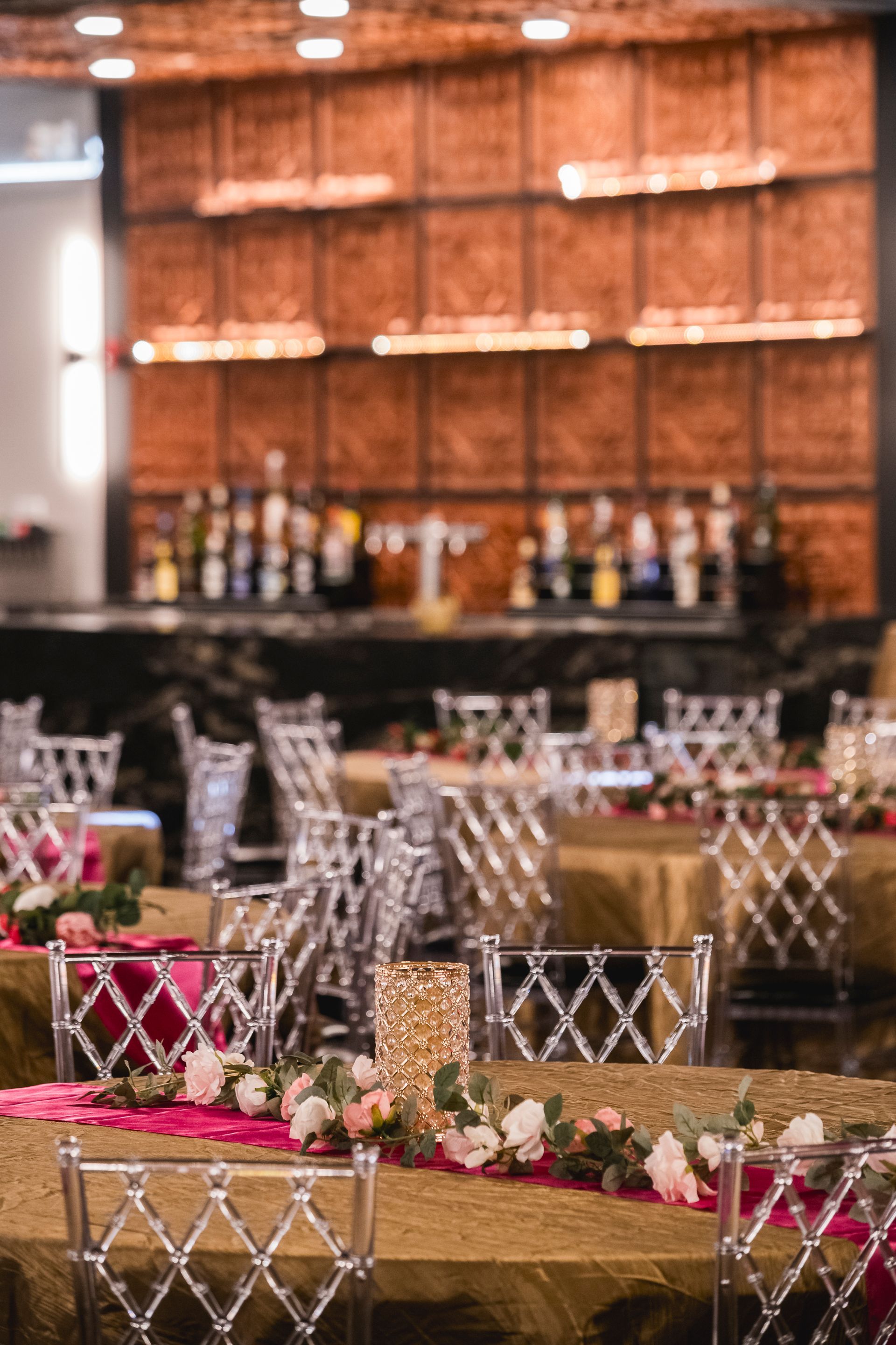 Decorated banquet tables with floral centerpieces and wine glasses in an elegant reception hall