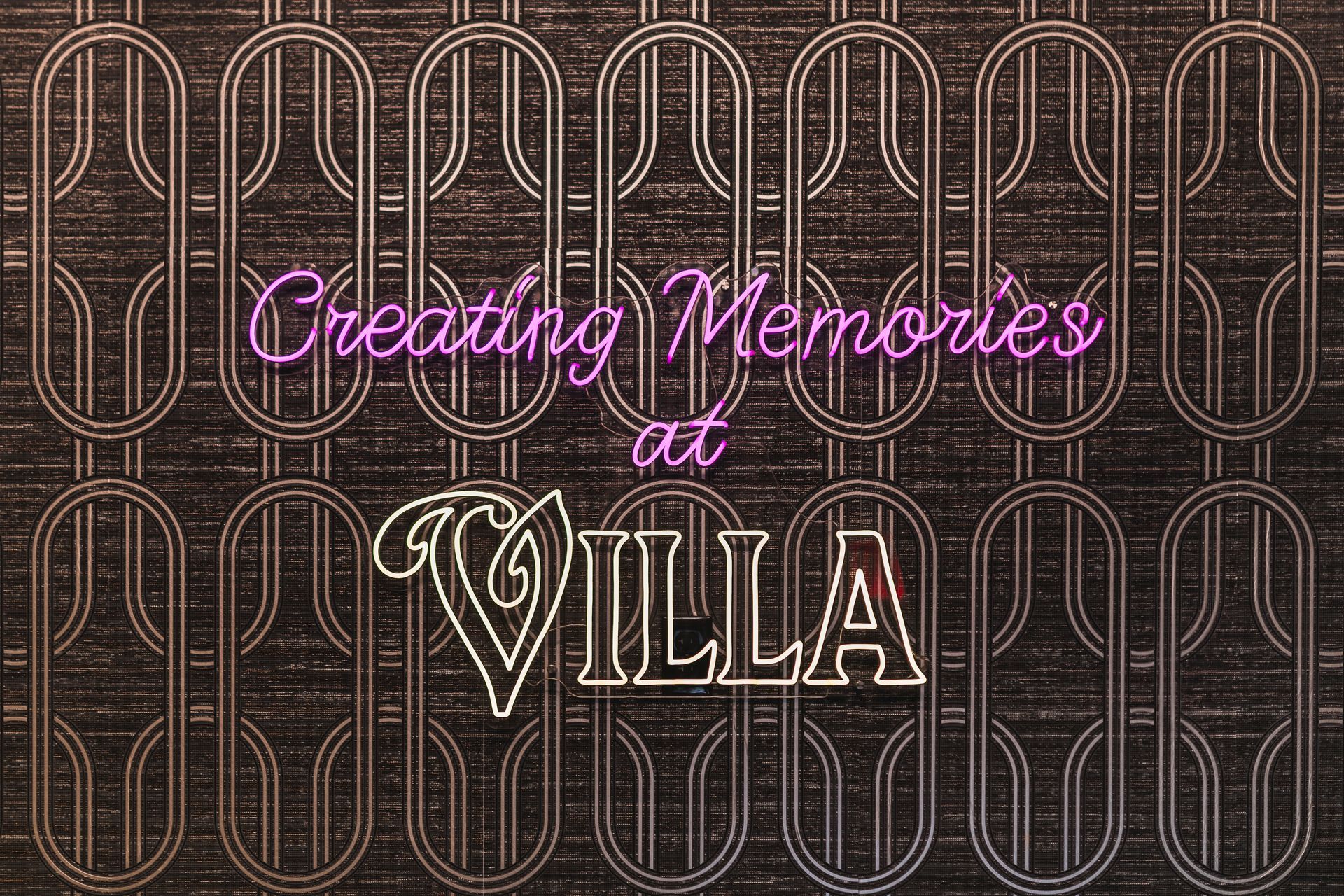 Creating Memories at Villa in pink and white script on a dark patterned background