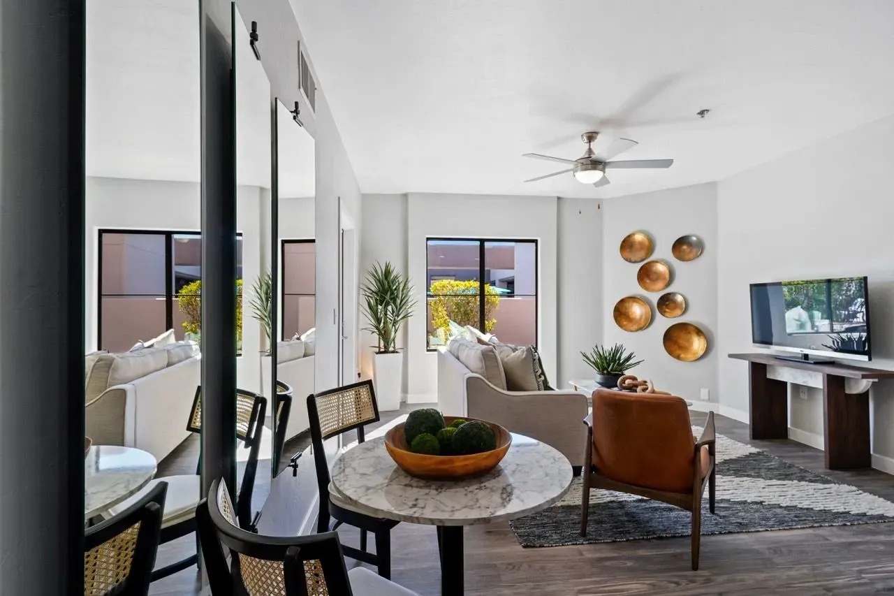Living room with dining area and a television.