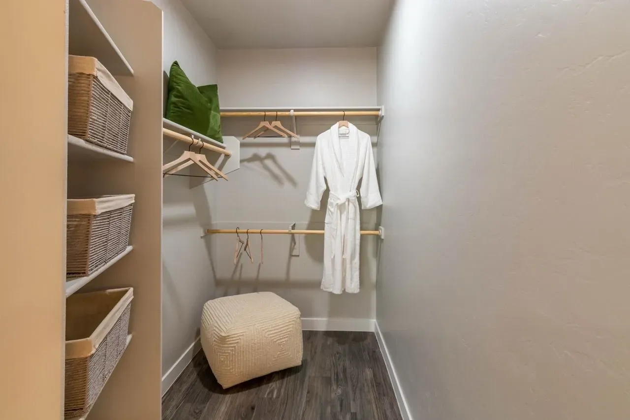 Walk-in closet with shelving and hanging rods