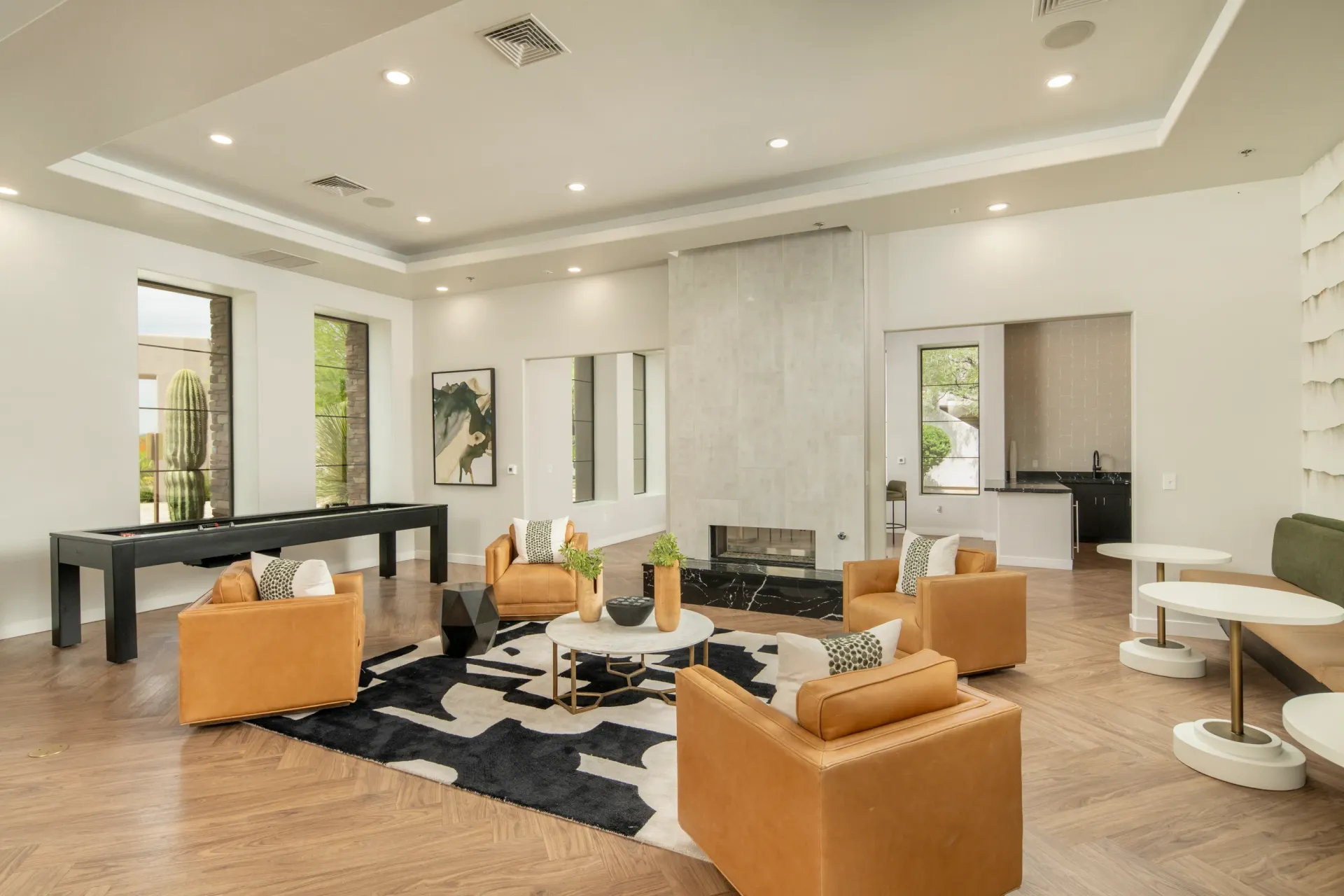 Modern lounge area with pool table, fireplace, and seating.