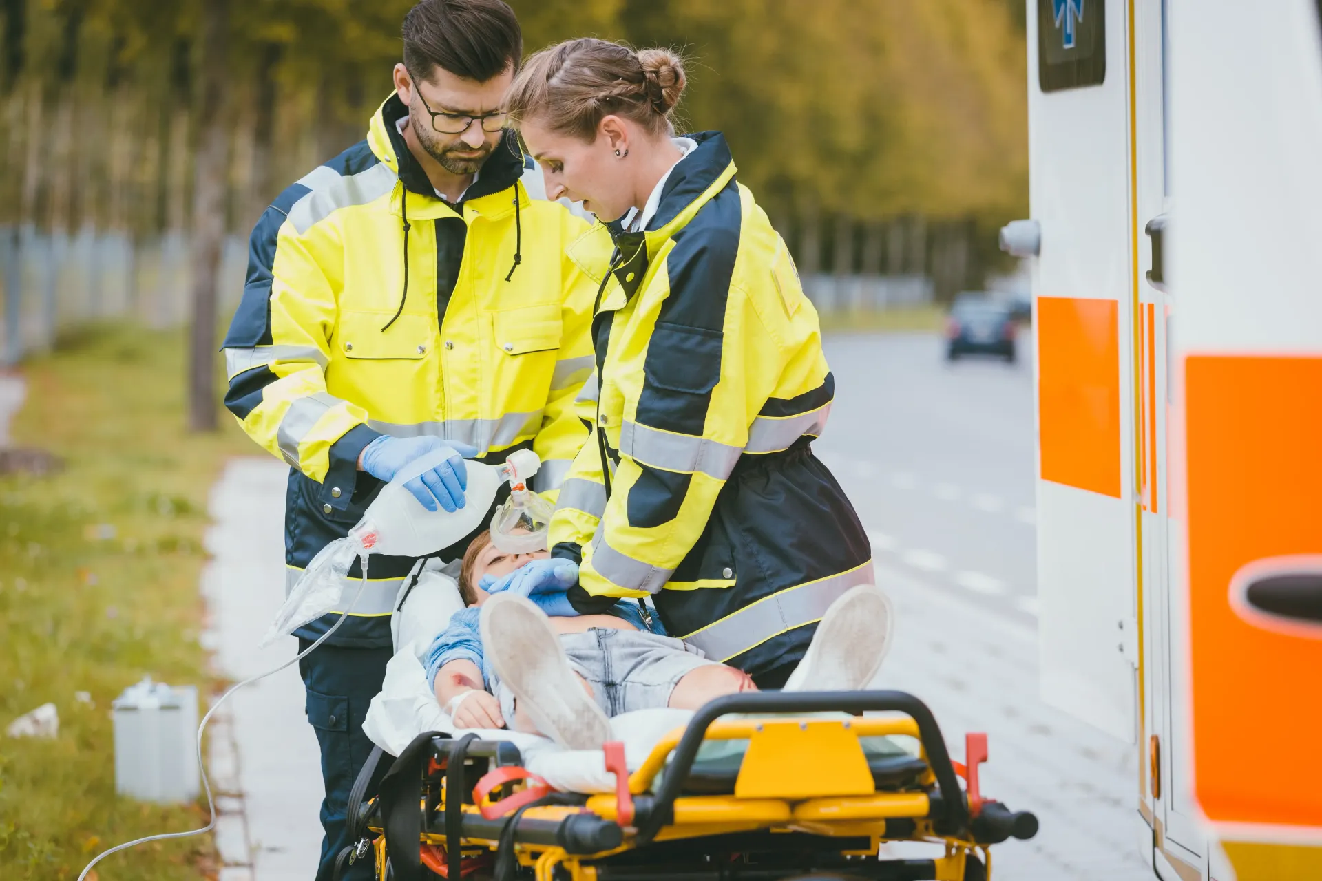 A group of paramedics are carrying a child on a stretcher.