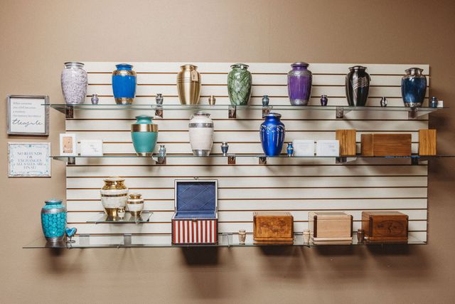 Wall-mounted display of colorful mugs and small decor items on wooden shelves
