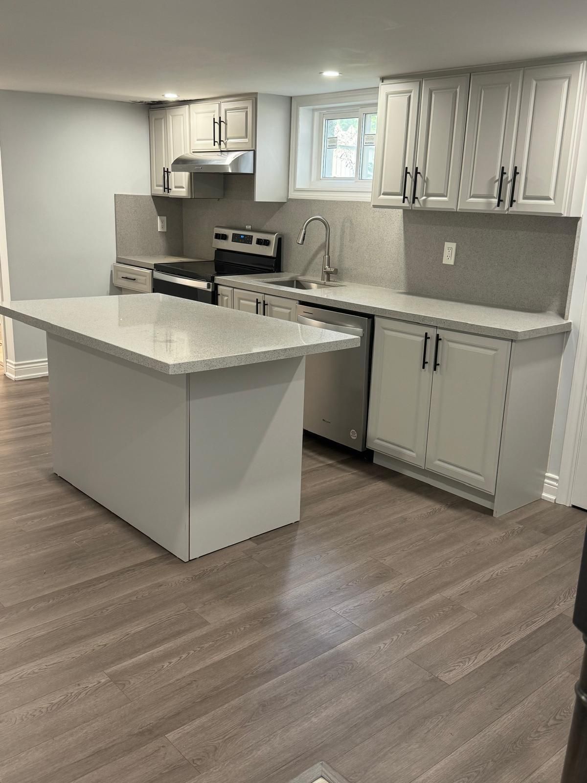 There is a large island in the middle of the kitchen.