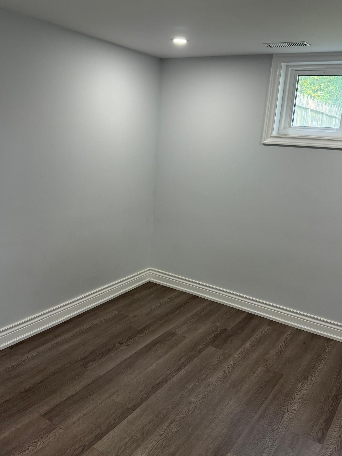 There is a window in the corner of the room.
