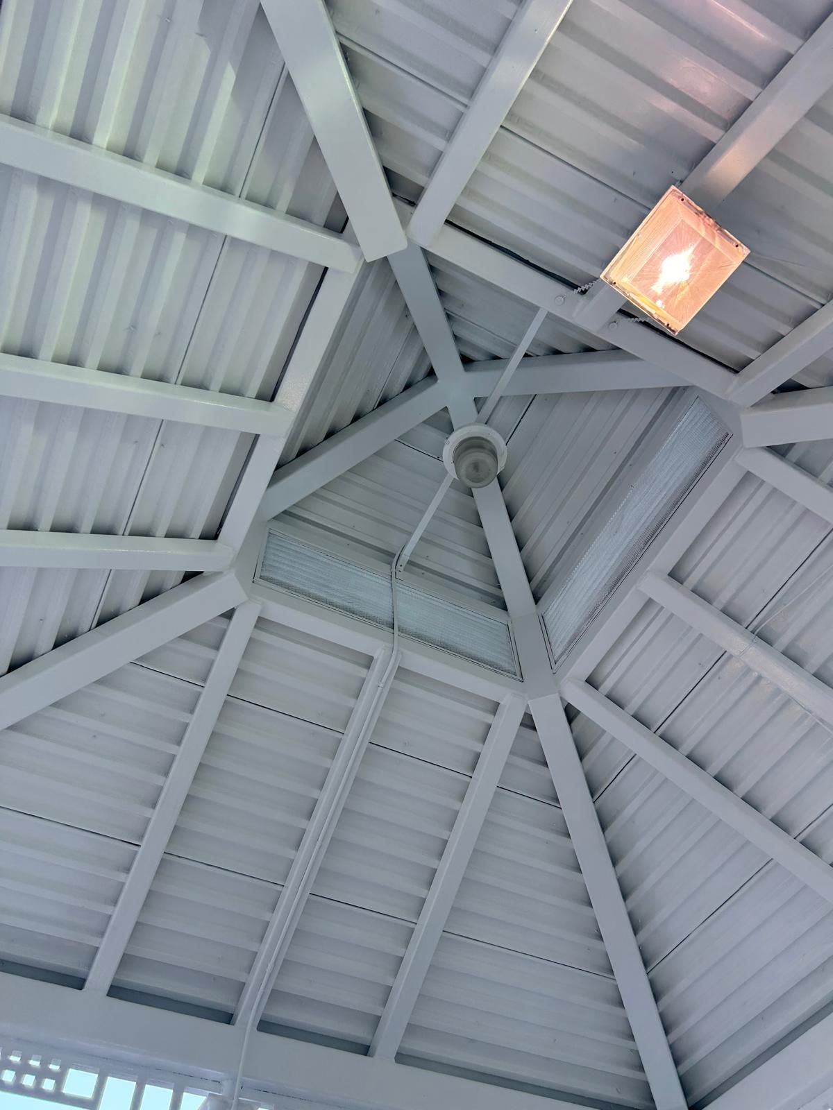 A ceiling fan is hanging from the ceiling of a building