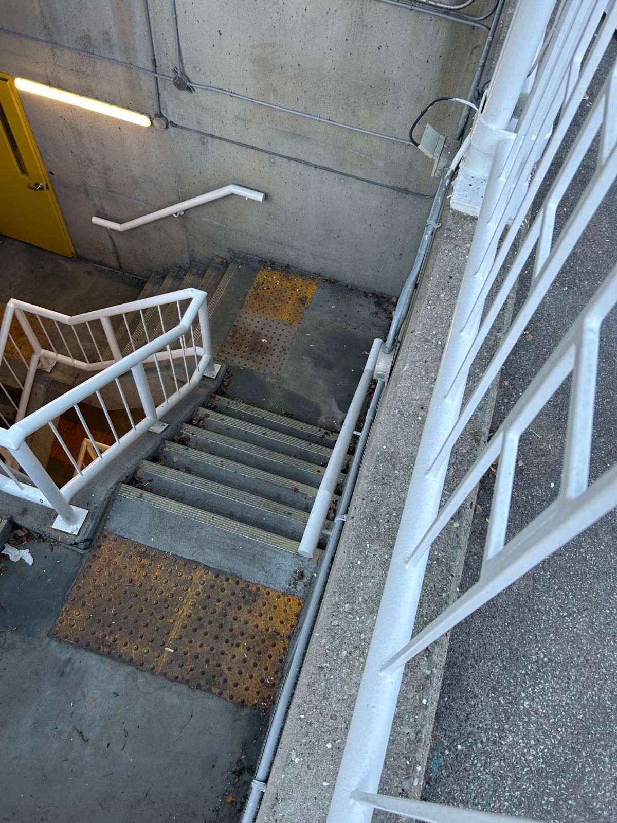 An aerial view of a set of stairs with a white railing.