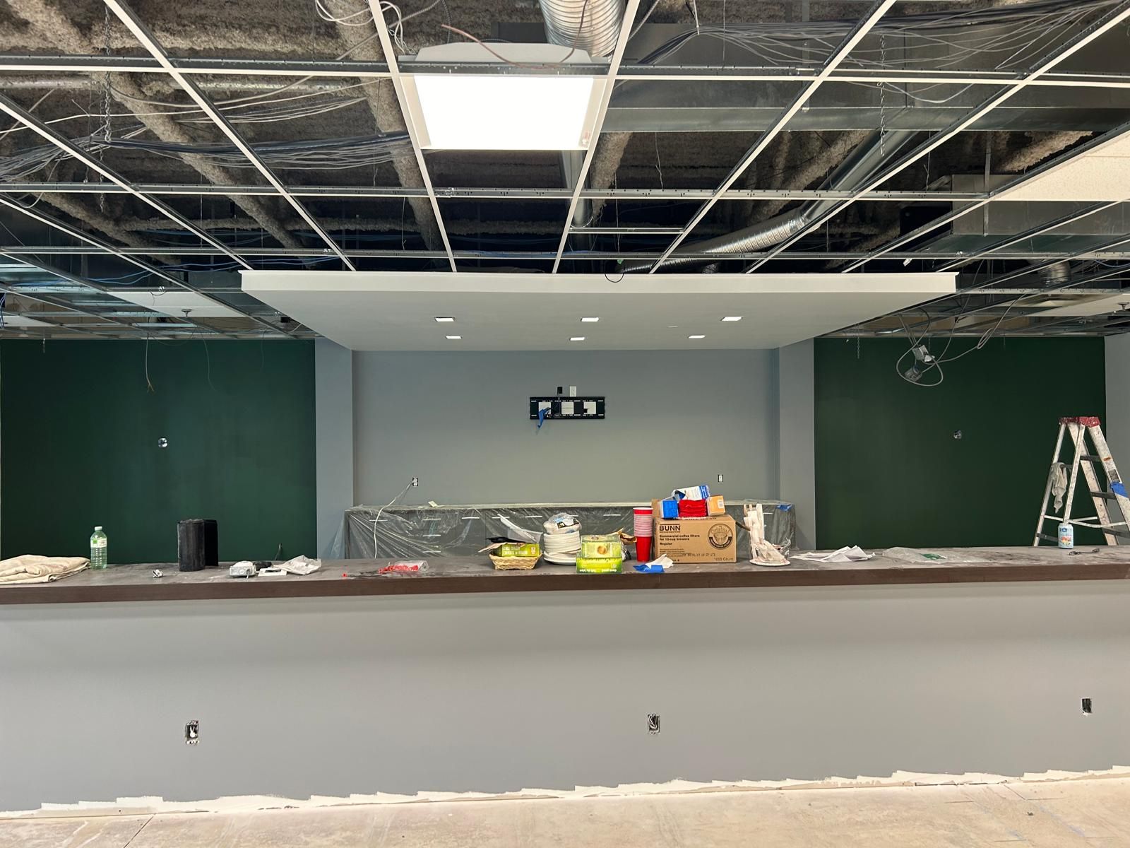 A bar in a building under construction with a ladder in the background.