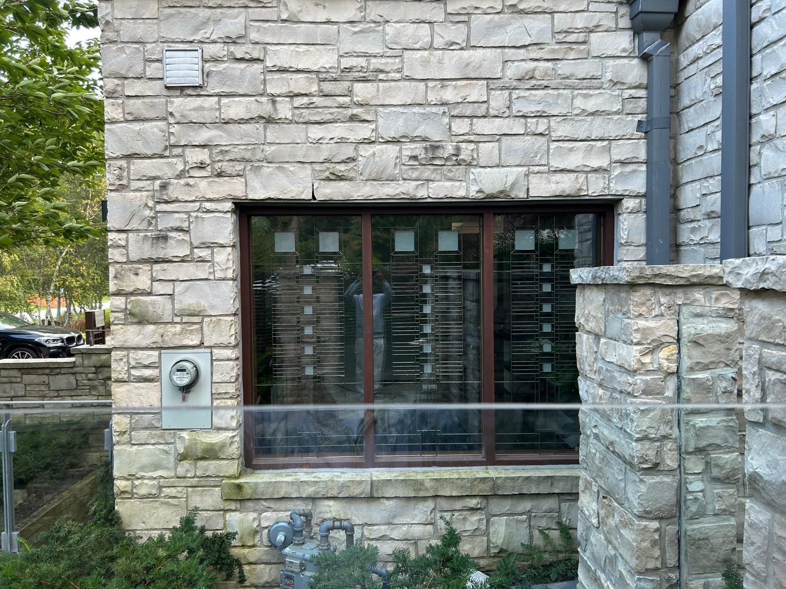 A brick building with a large window on the side of it.
