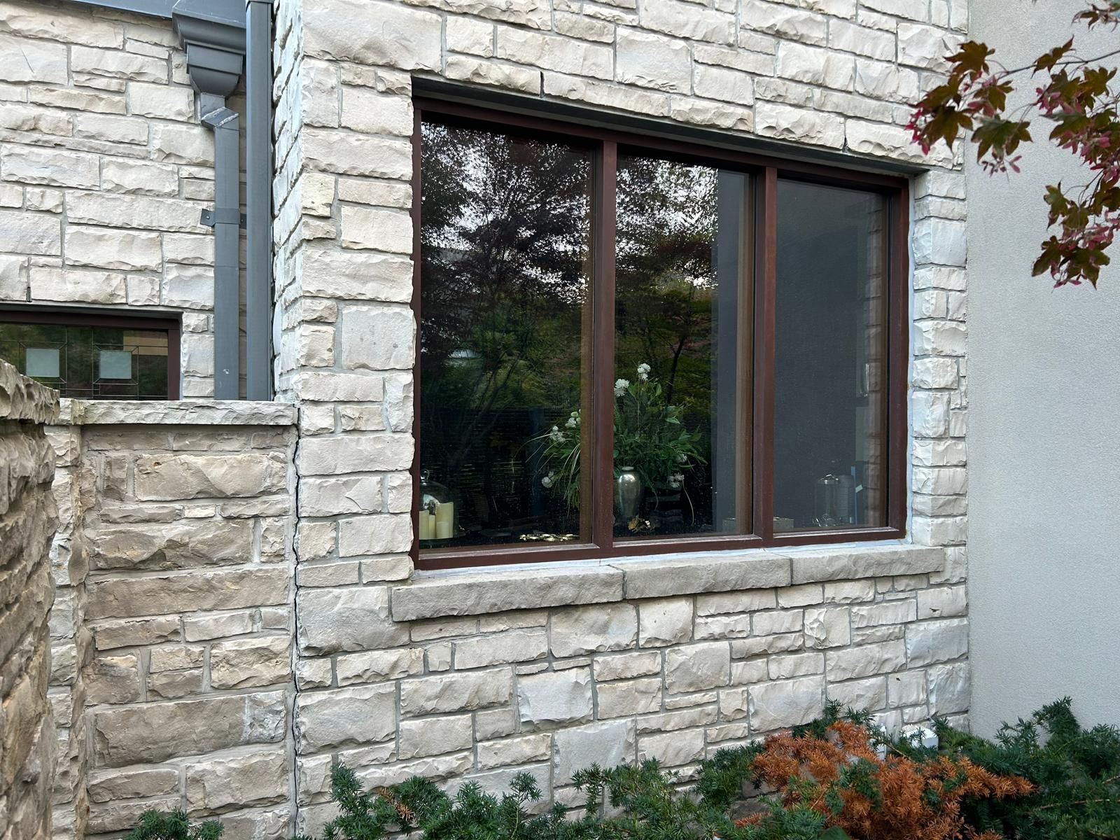 A large window on the side of a brick building