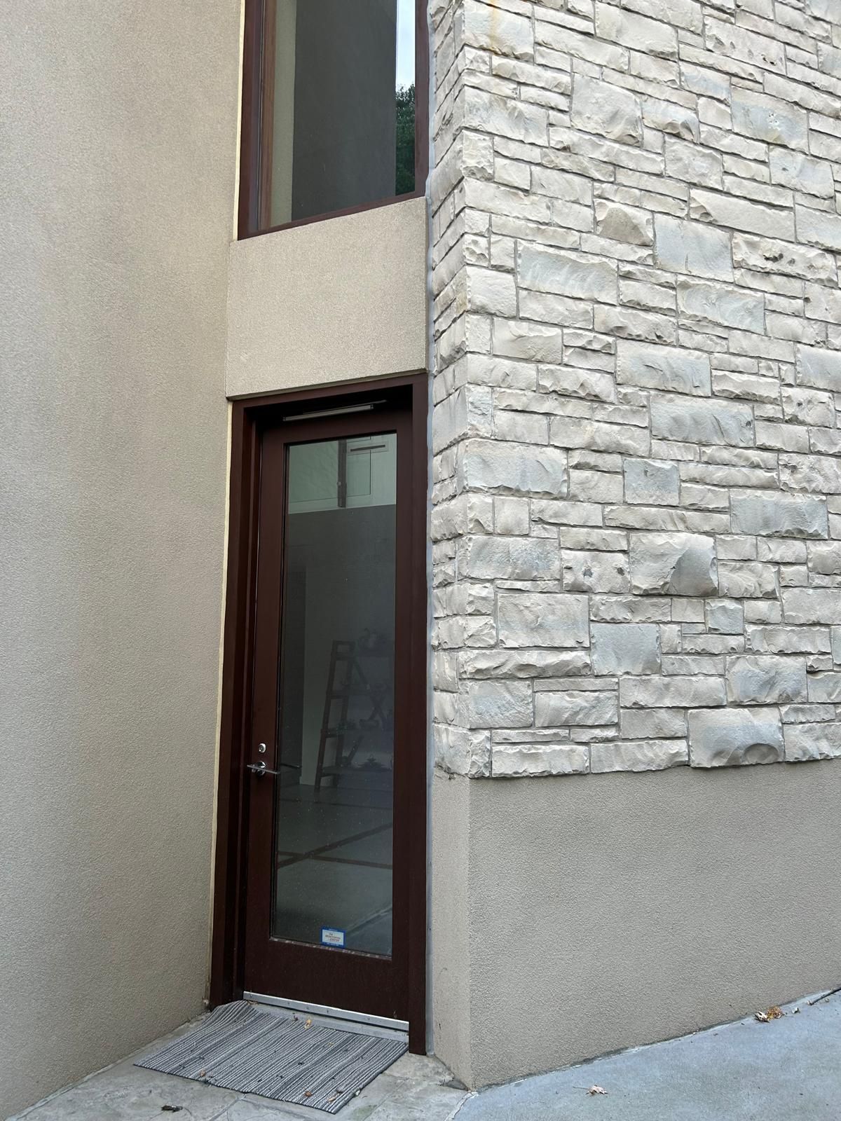 A brick building with a door and a window