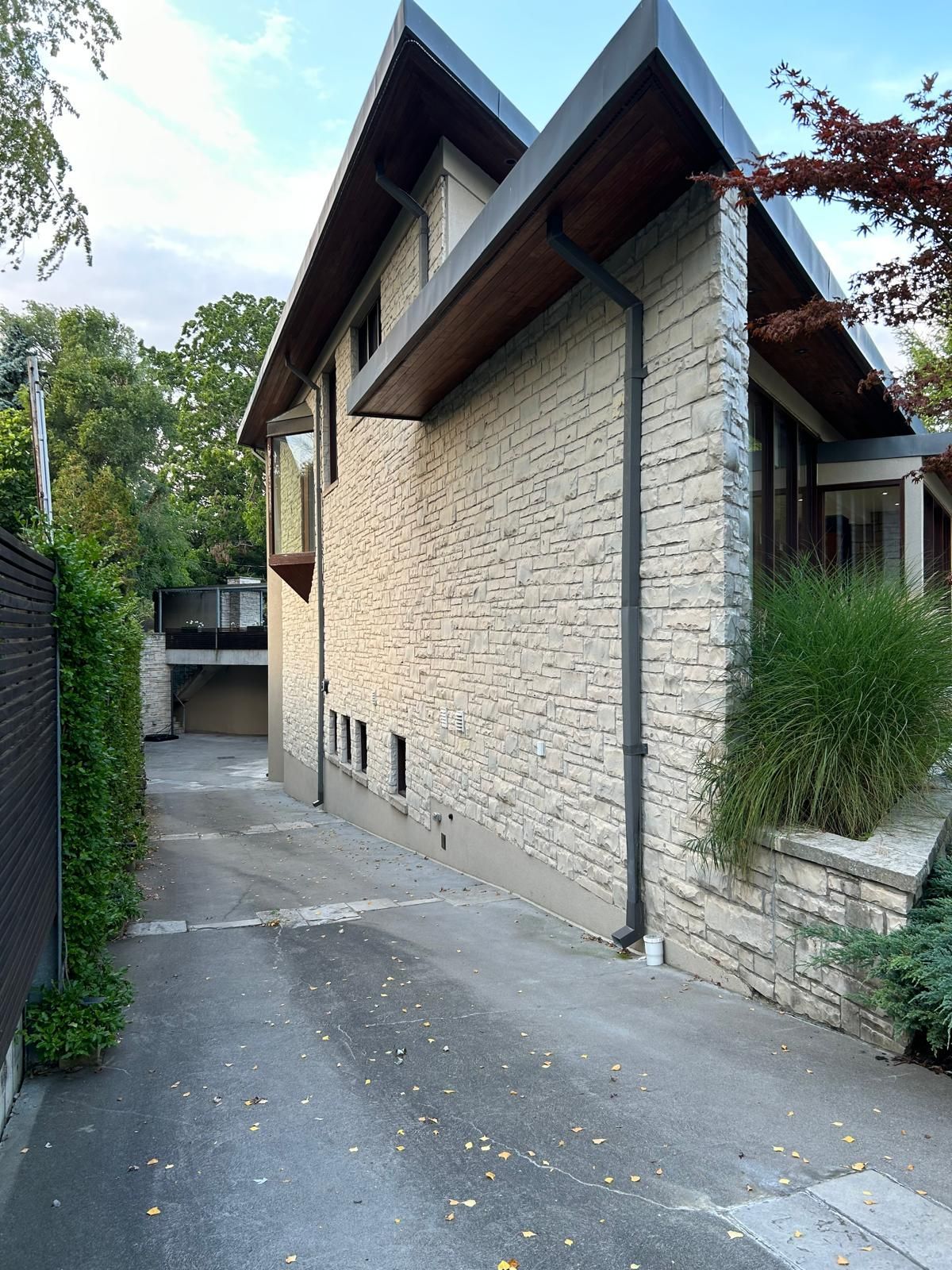 A brick house with a driveway leading to it