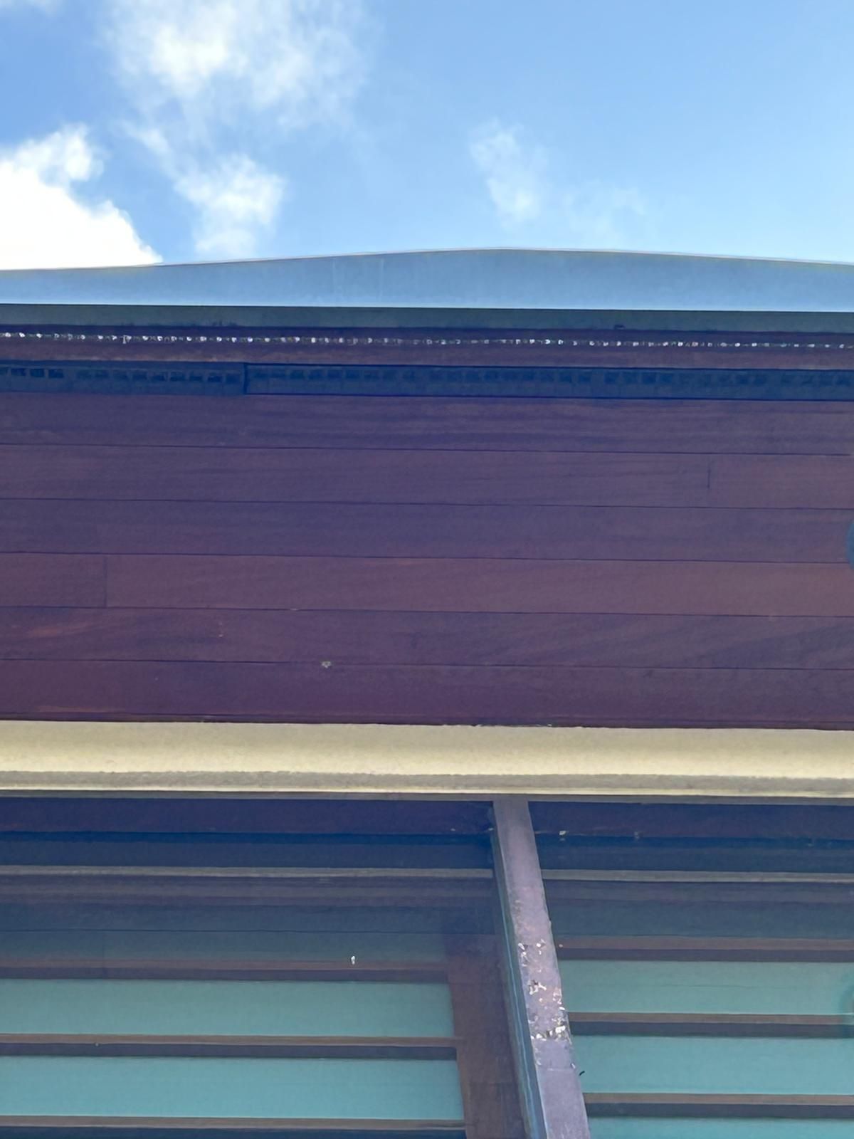 A close up of the roof of a building with a blue sky in the background.