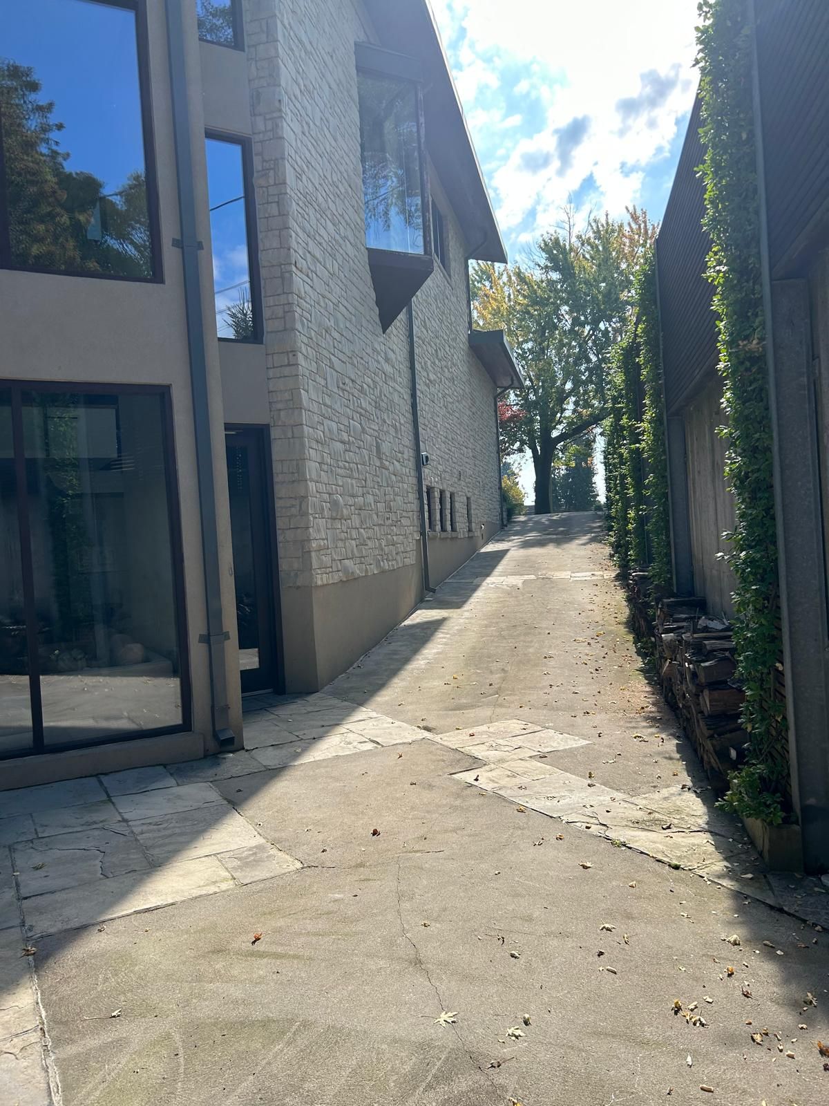 A narrow alleyway between two buildings on a sunny day