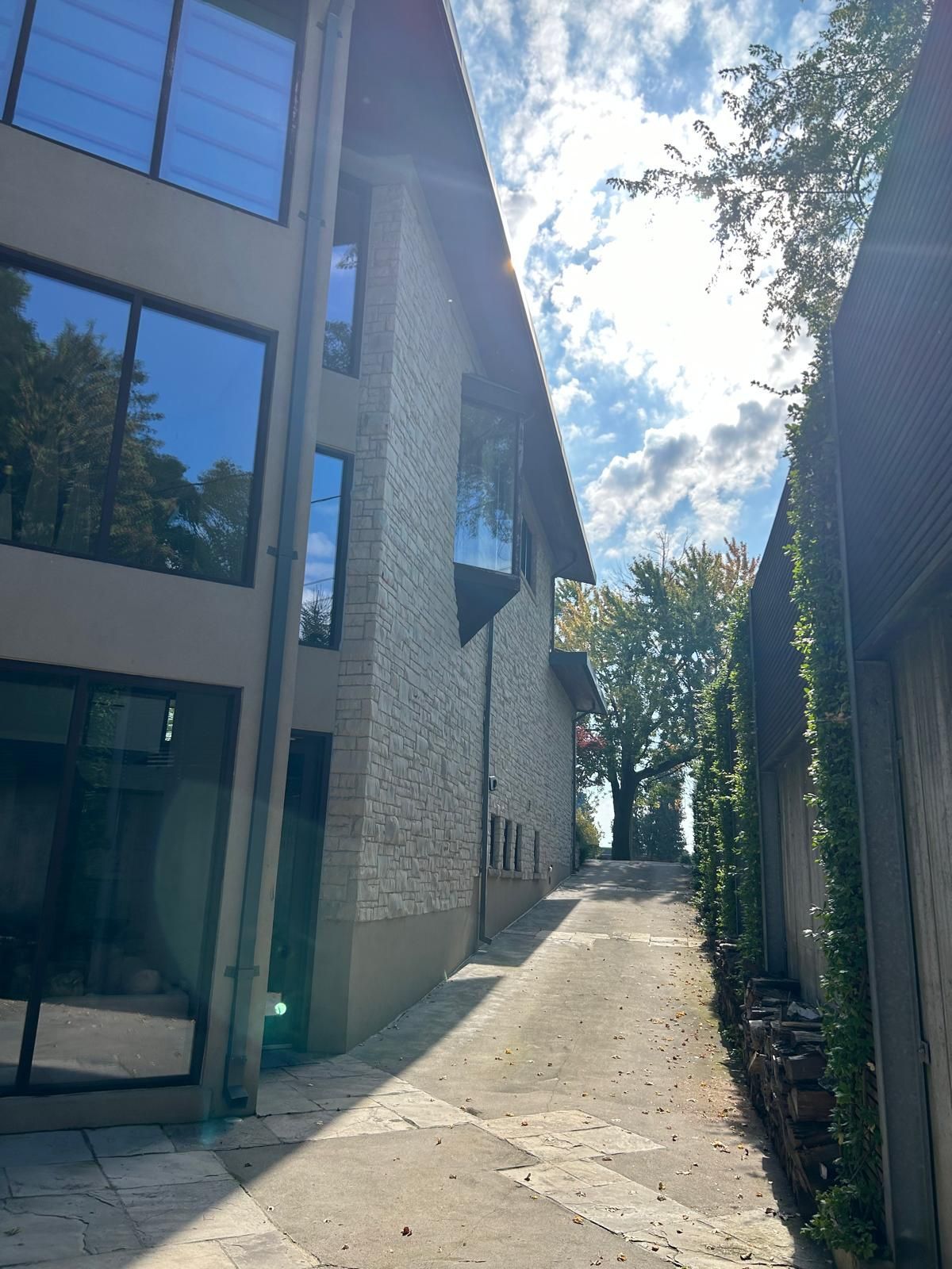 A narrow alleyway between two buildings on a sunny day