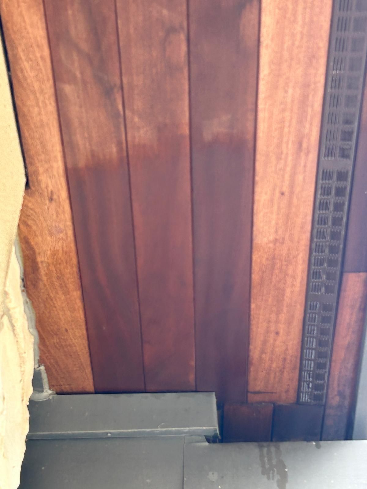 A close up of a wooden door with holes in it