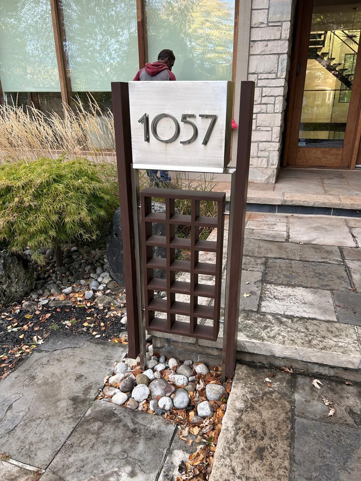 A sign with the number 1057 on it is in front of a building.