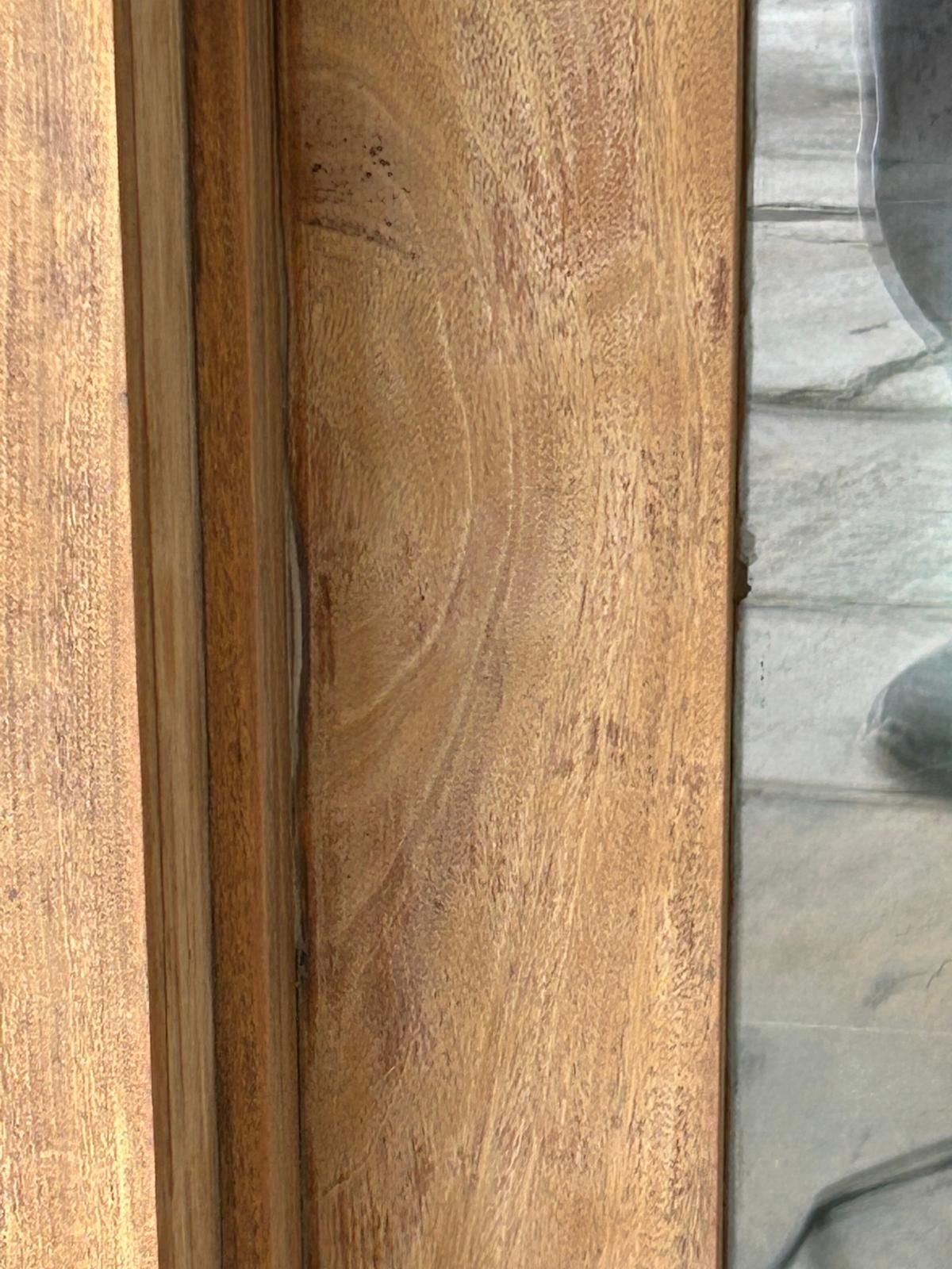 A close up of a wooden door with a glass window.