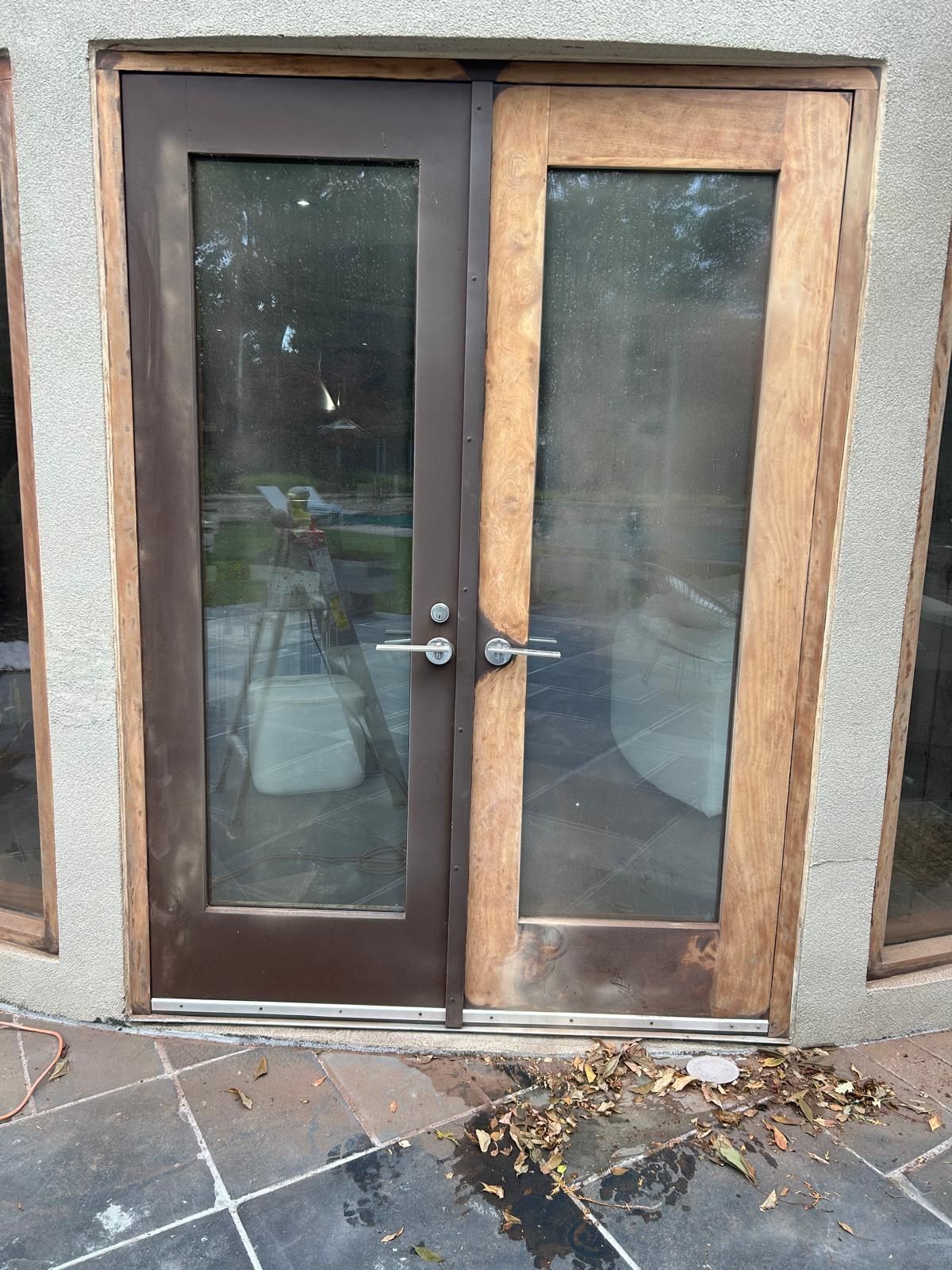 A sliding glass door is being installed on a building