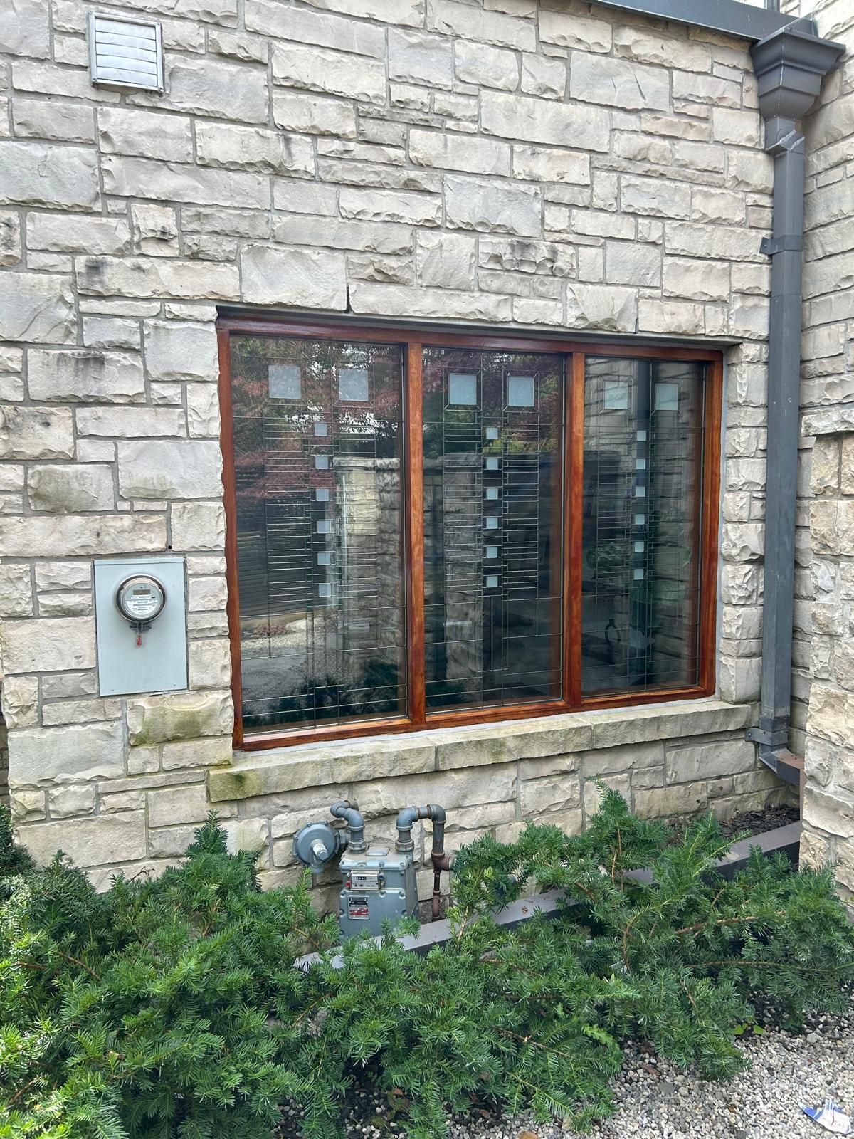 A large window on the side of a brick building.