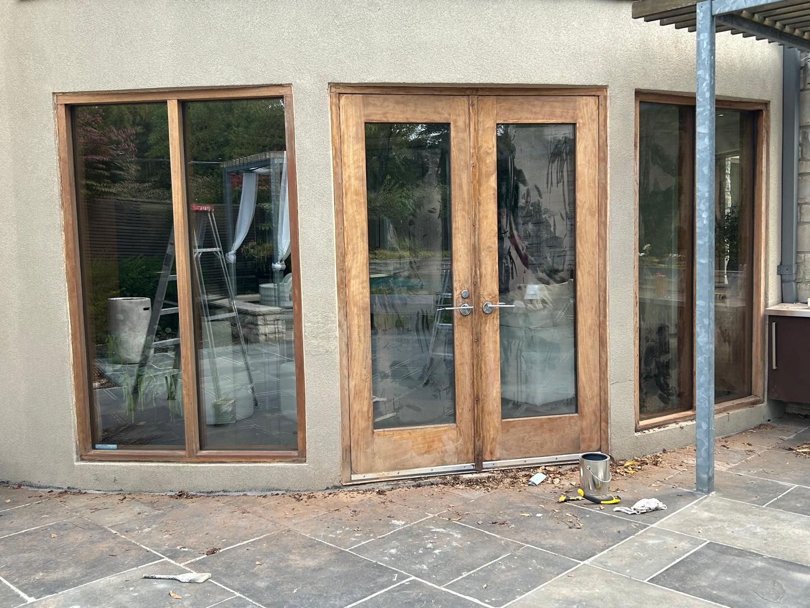 A house with a lot of windows and wooden doors