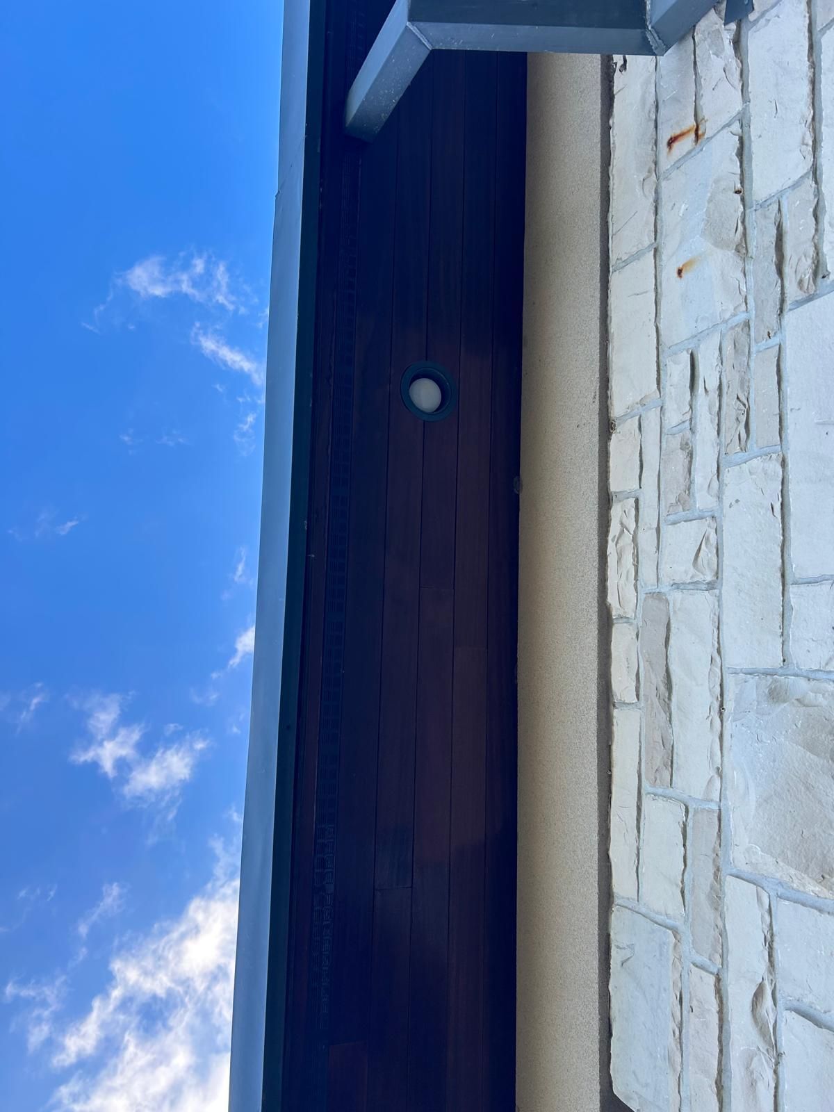 A close up of a building with a blue sky in the background.