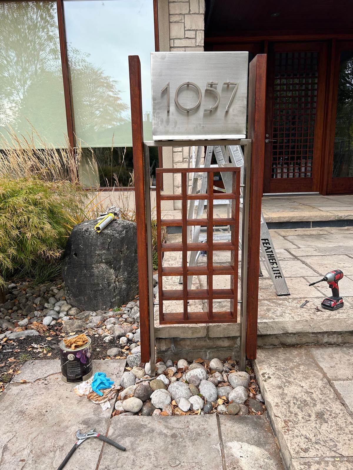 A wooden gate is being built in front of a building.