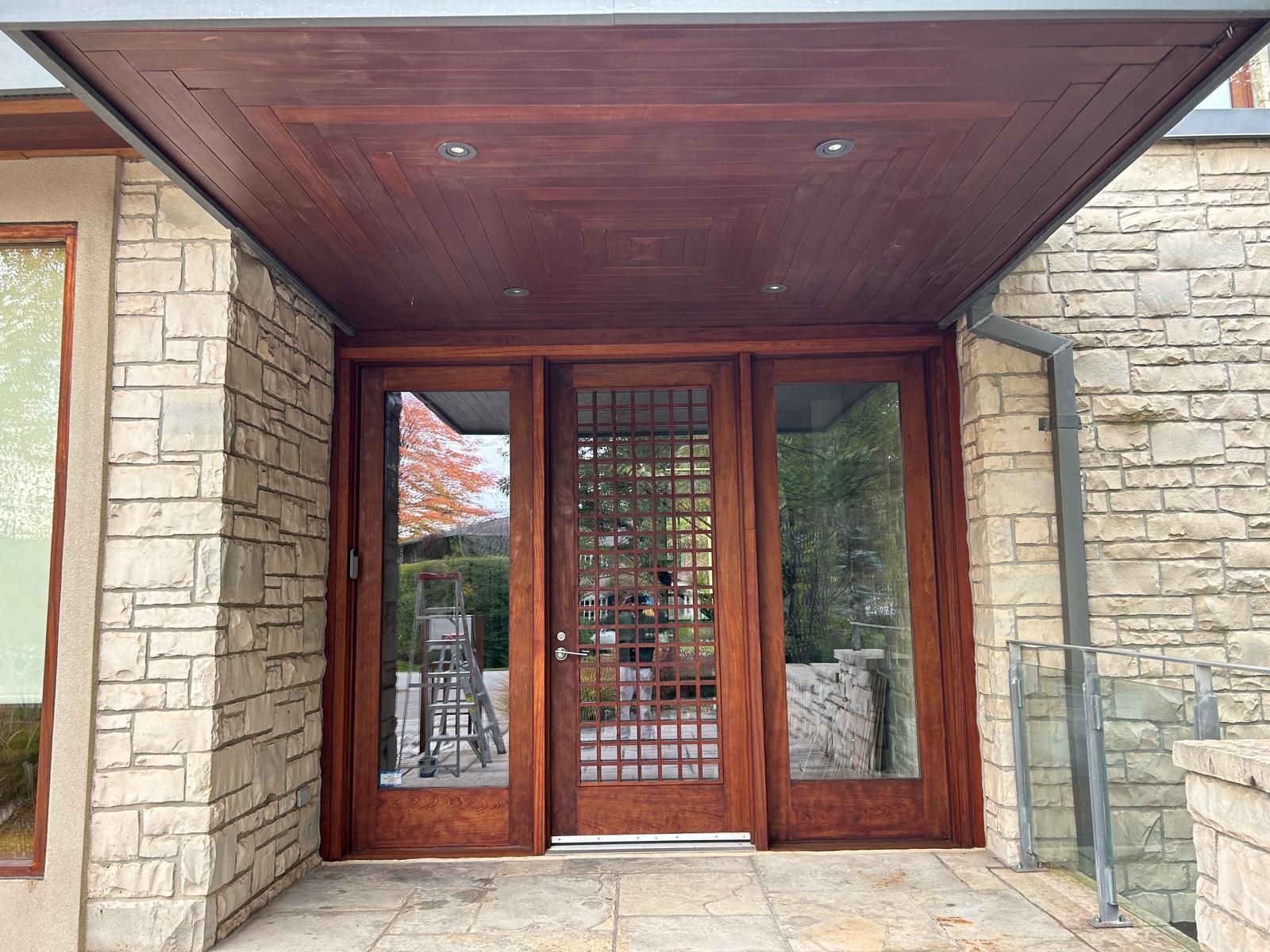 A brick building with a wooden door and a roof