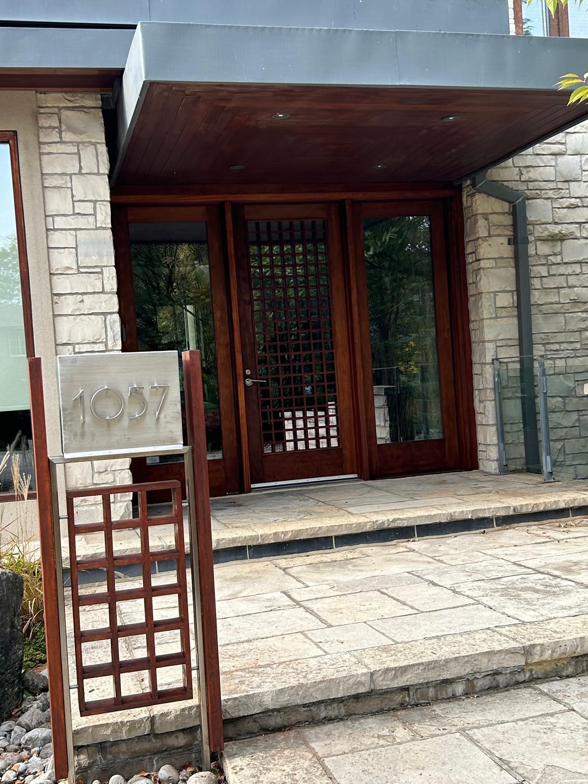 The front door of a house with a sign that says 1037 on it.