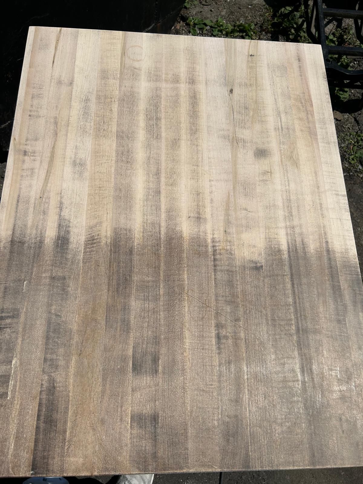 A piece of wood is sitting on top of a table.