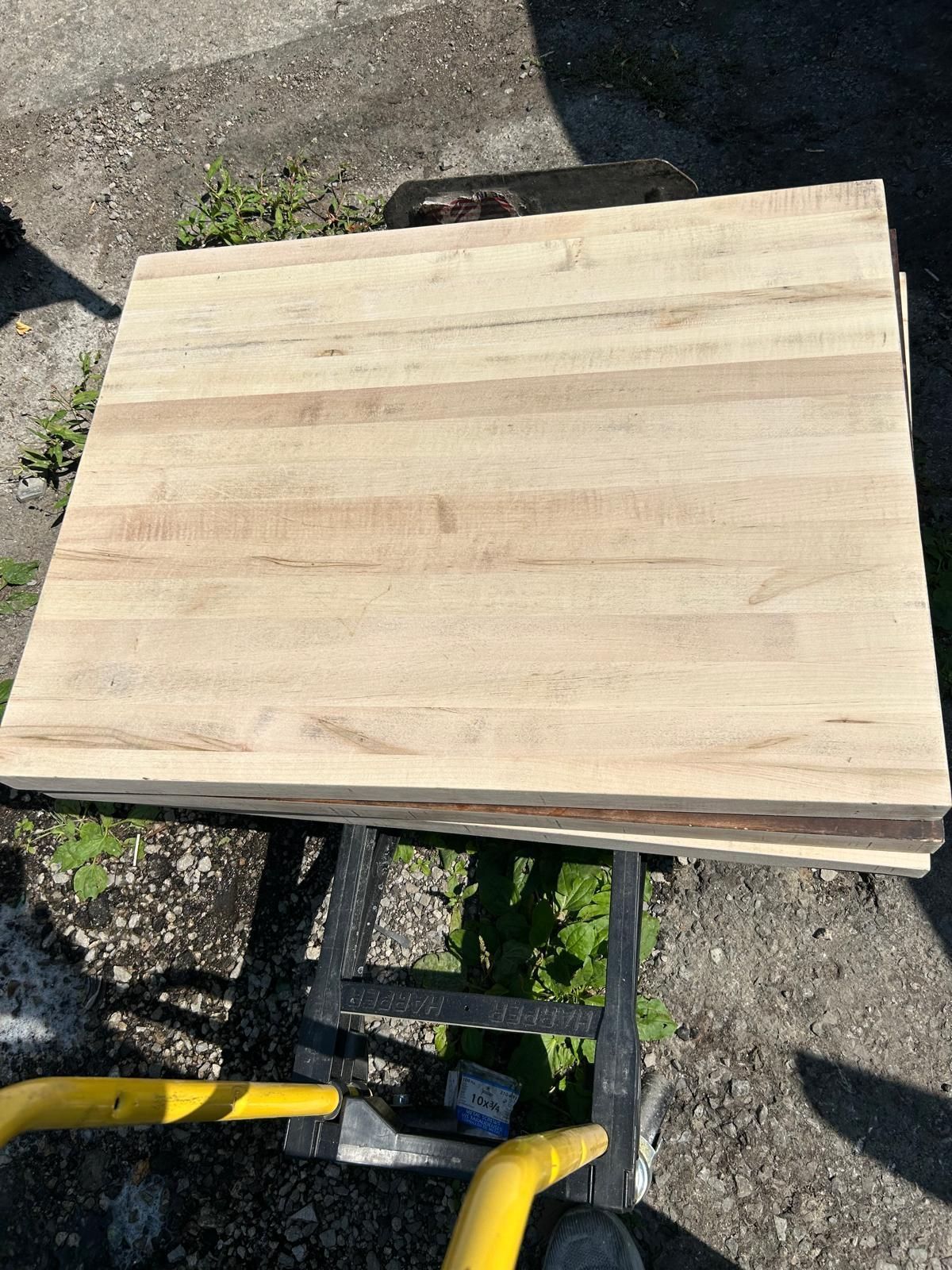 A stack of wooden boards is sitting on top of a cart.