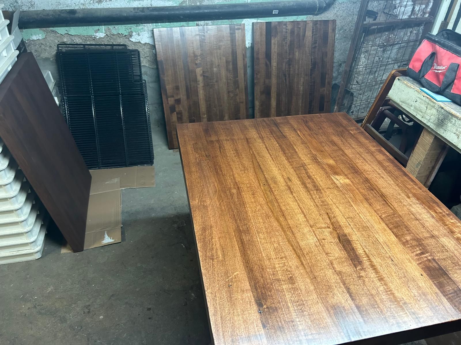 A wooden table is sitting in a room with other wooden pieces.