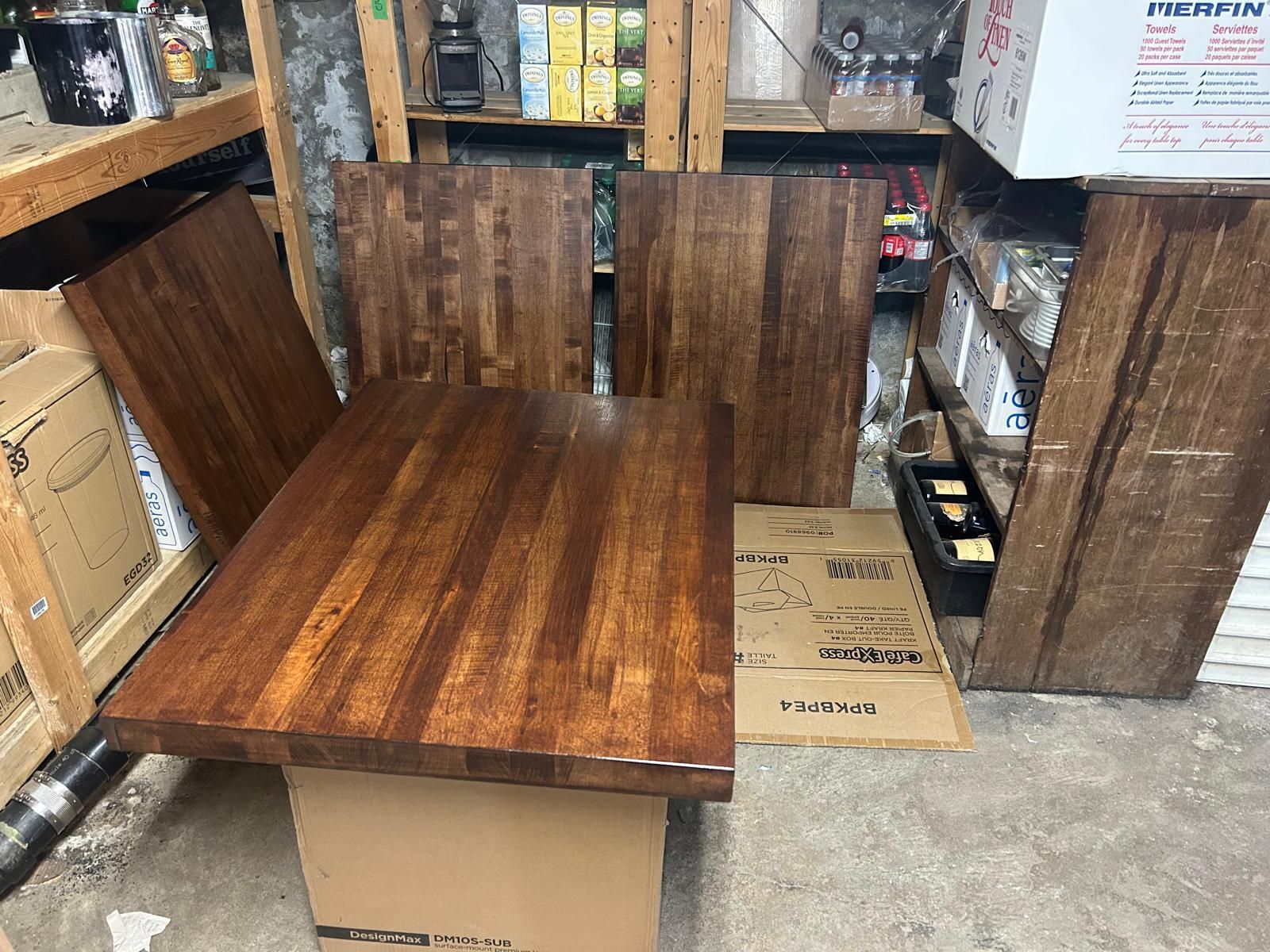 A wooden table is sitting on top of a cardboard box in a room.