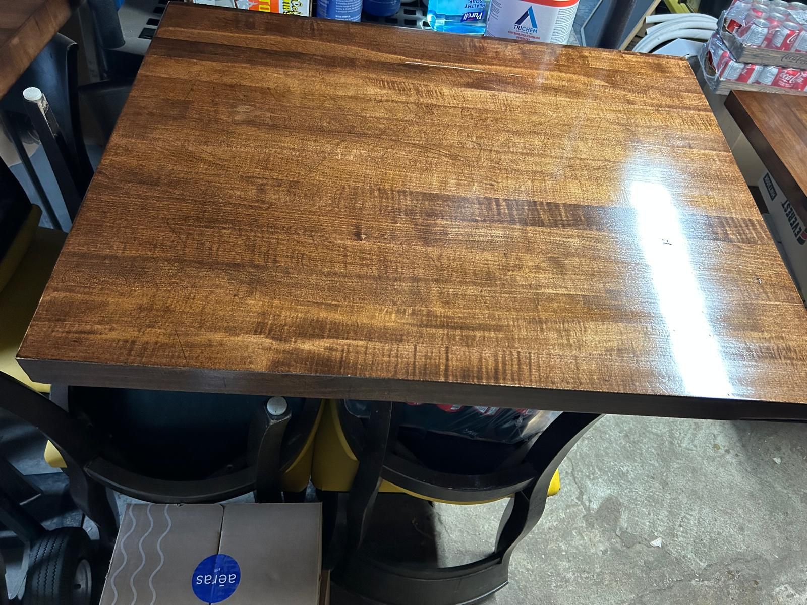 A wooden table and chairs are sitting in a garage.