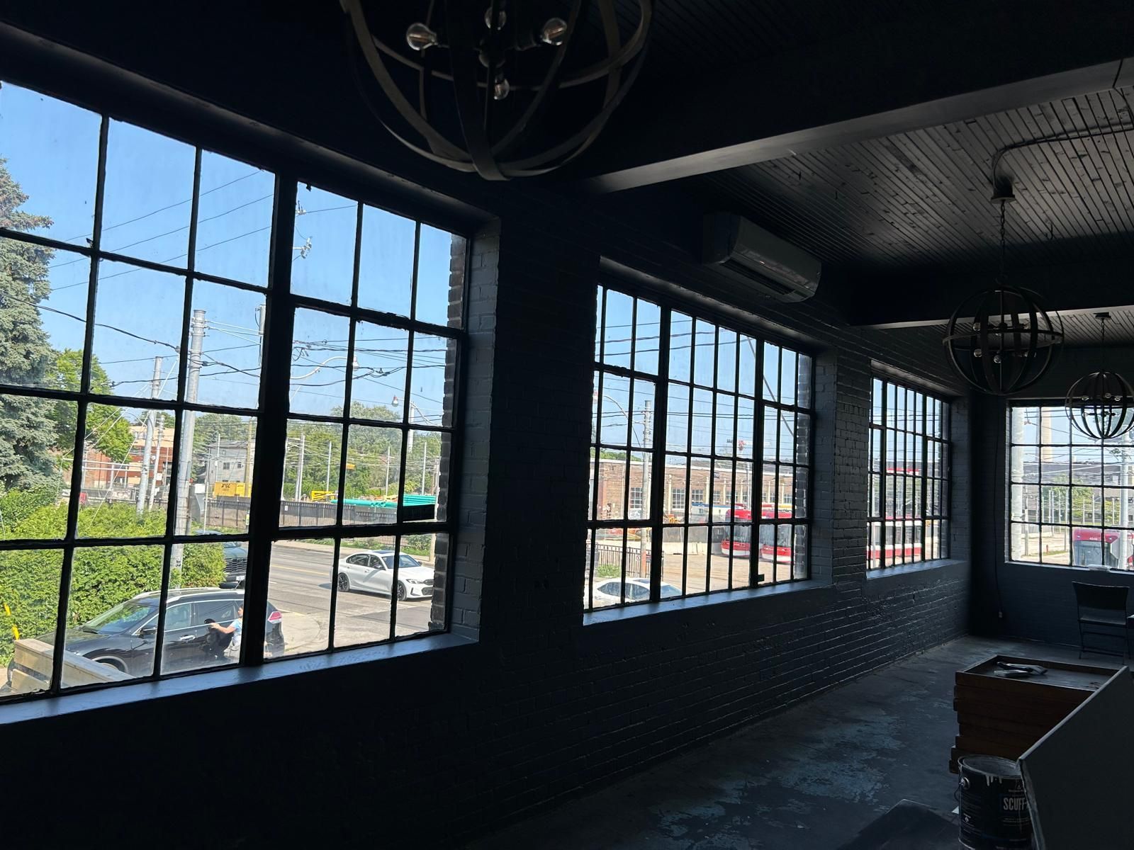A room with a lot of windows and a chandelier