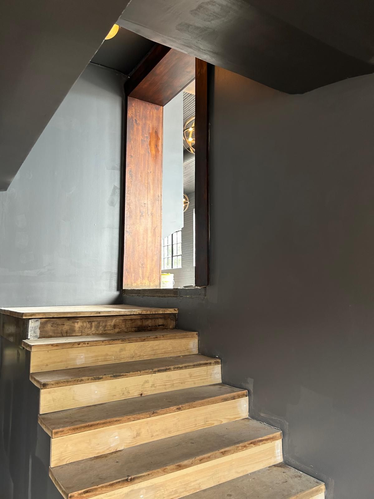 A set of stairs leading up to a doorway in a building.