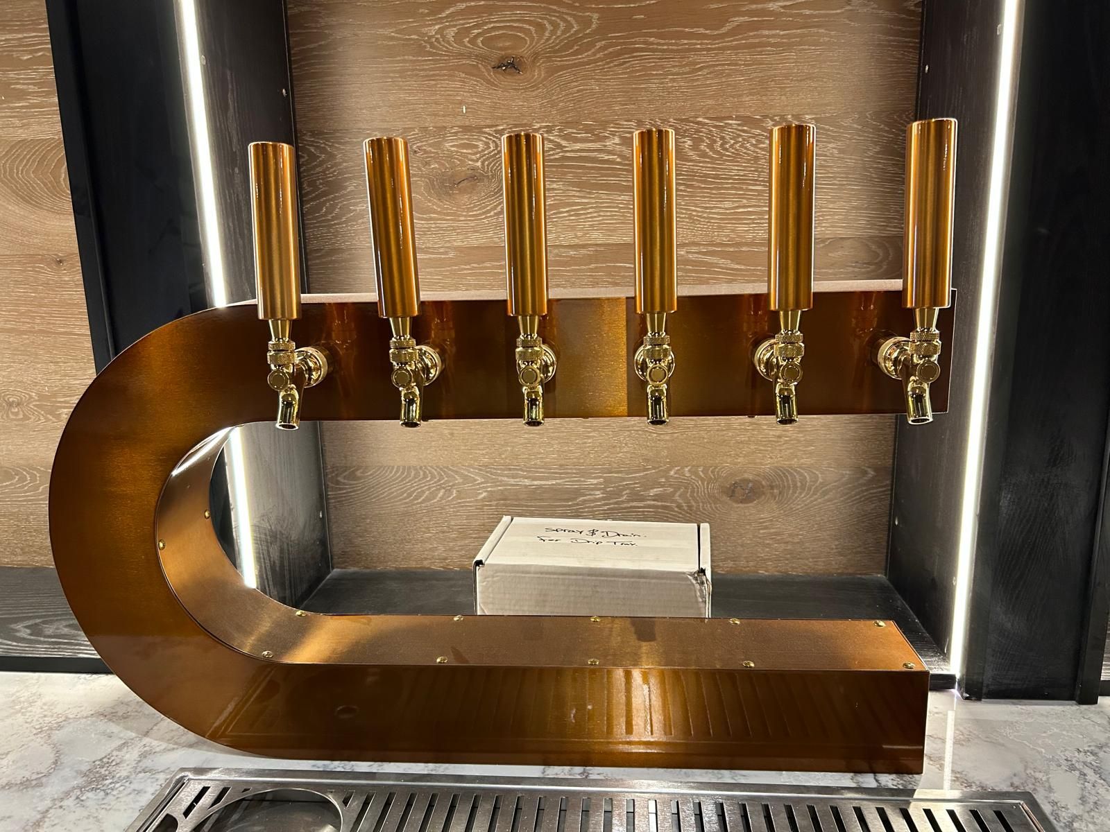 A bar with brass taps and a box on the counter