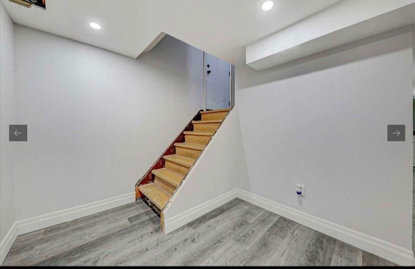 An empty room with stairs leading up to the second floor.