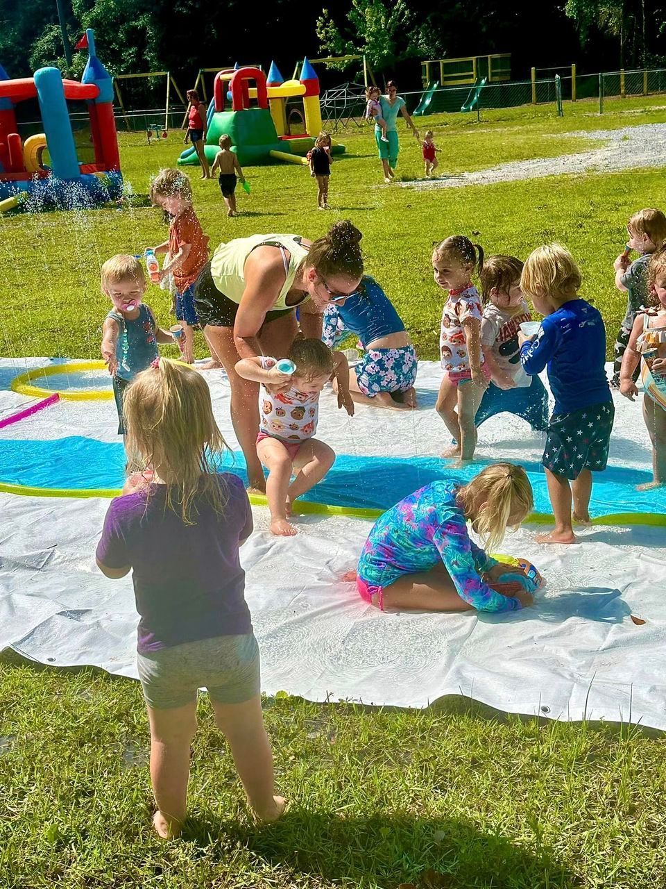 daycare kids outside playing in water