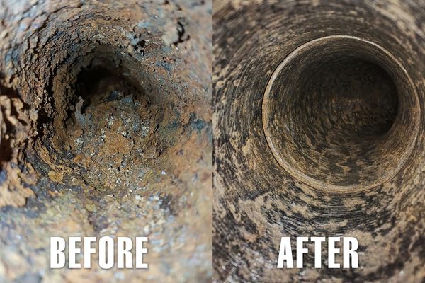 Blue pipes in a trench, ready for burial. Surrounded by gravel and dirt.