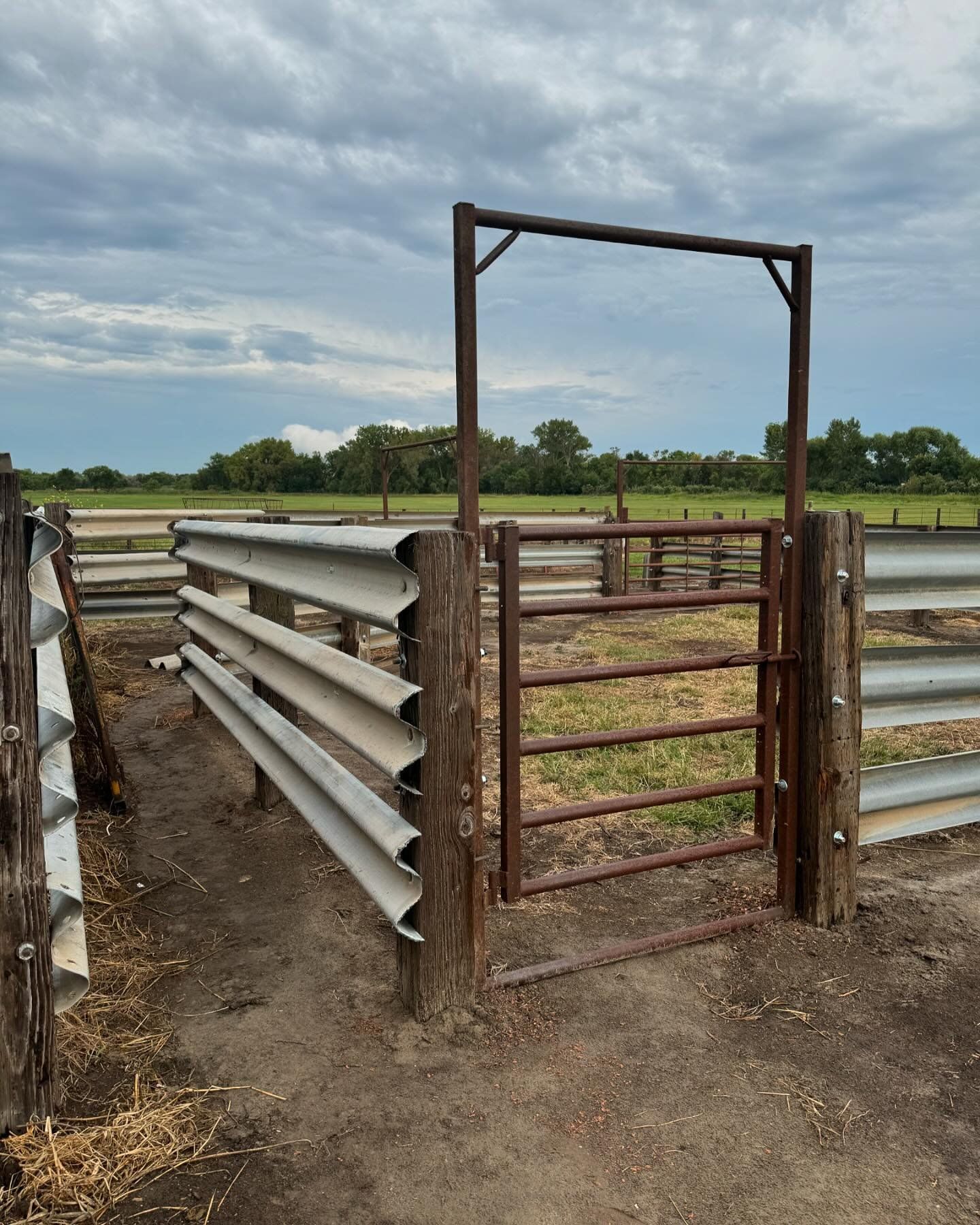A metal fence with a gate in the middle of it