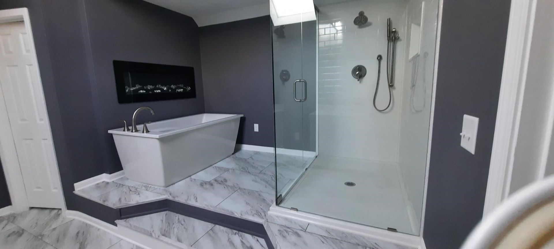 A bathroom with a bathtub and a walk in shower.
