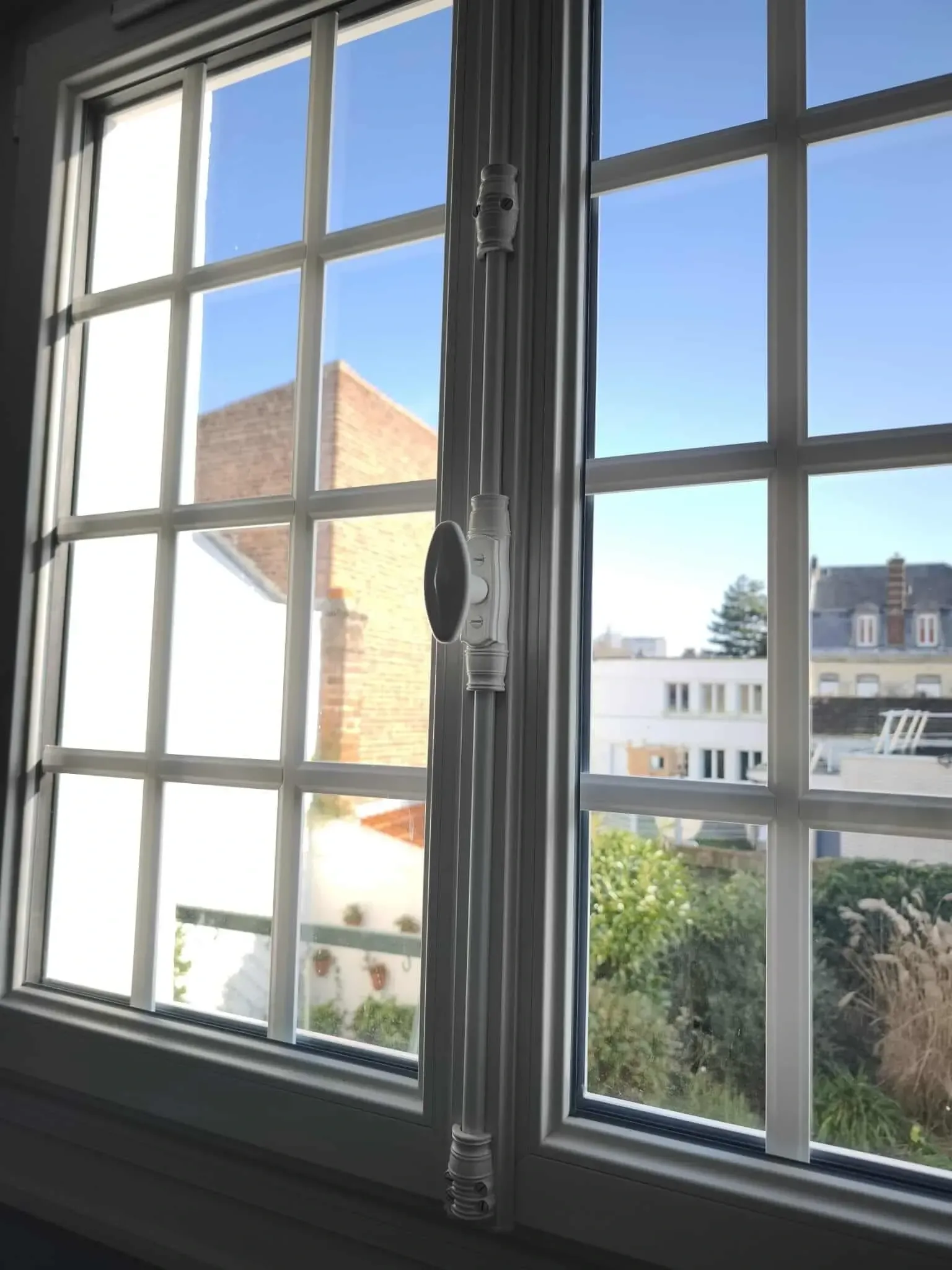Un gros plan d'une fenêtre avec vue sur une ville.