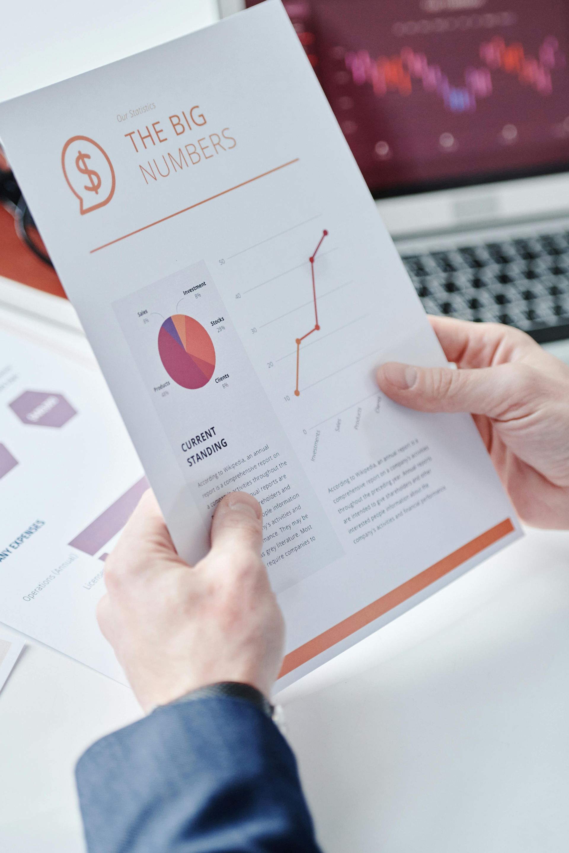 Person holding a report titled
