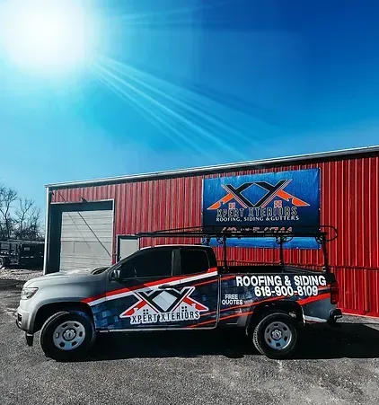 A truck is parked in front of a red building.