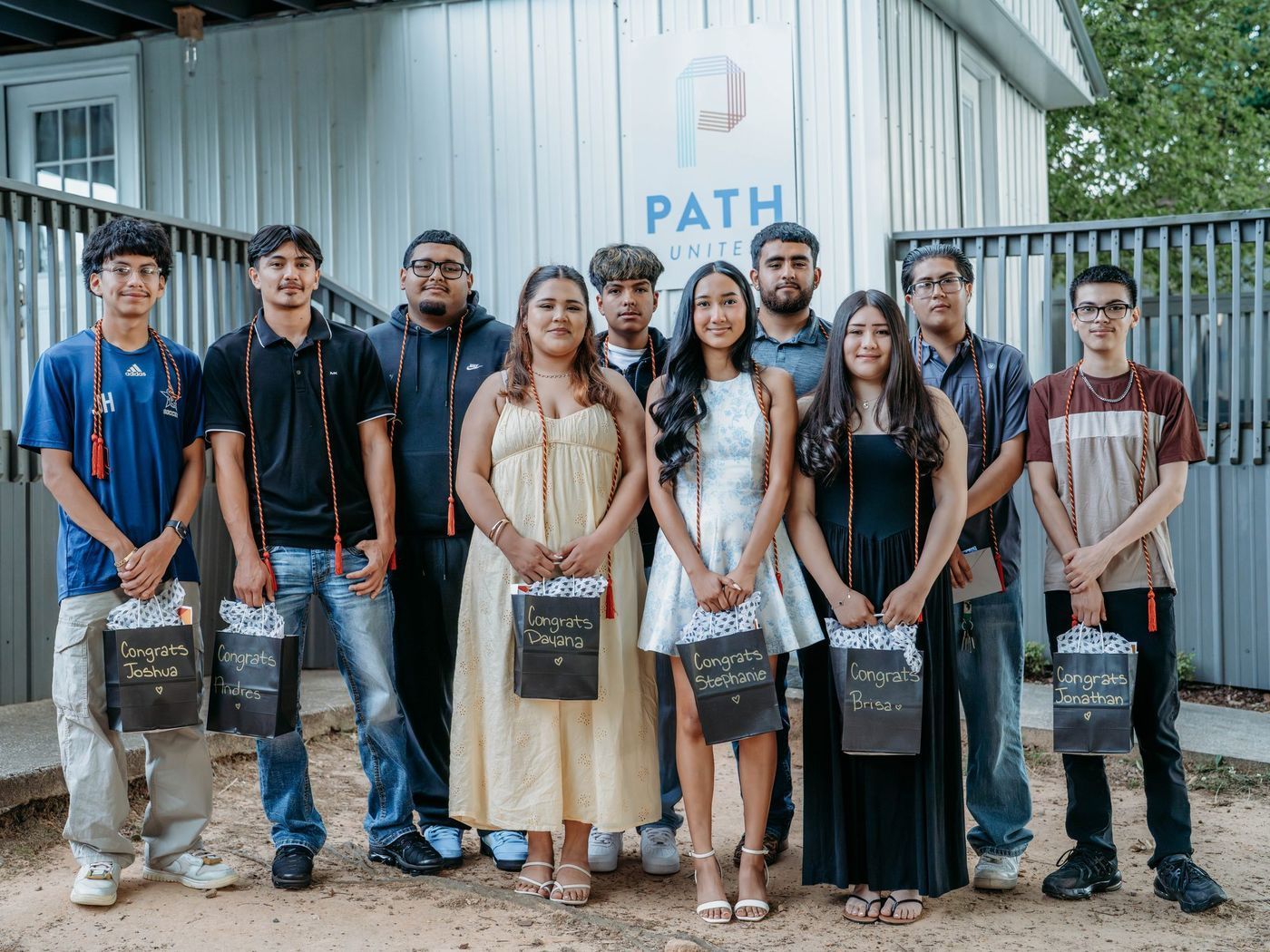 Path United graduates standing together outside their community center