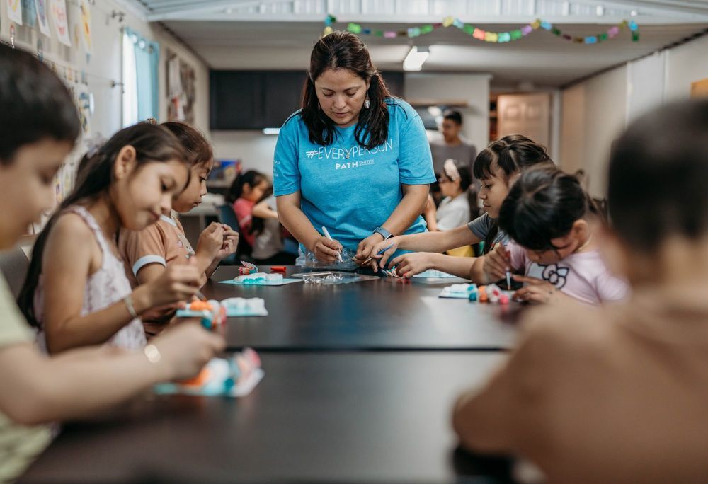 Students working on a hands-on project around a long table